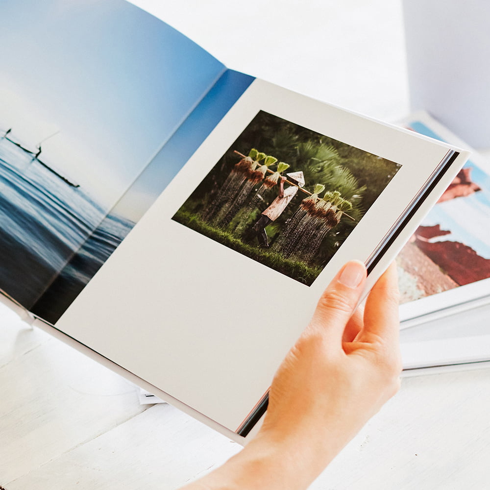Person holding hardcover photo book